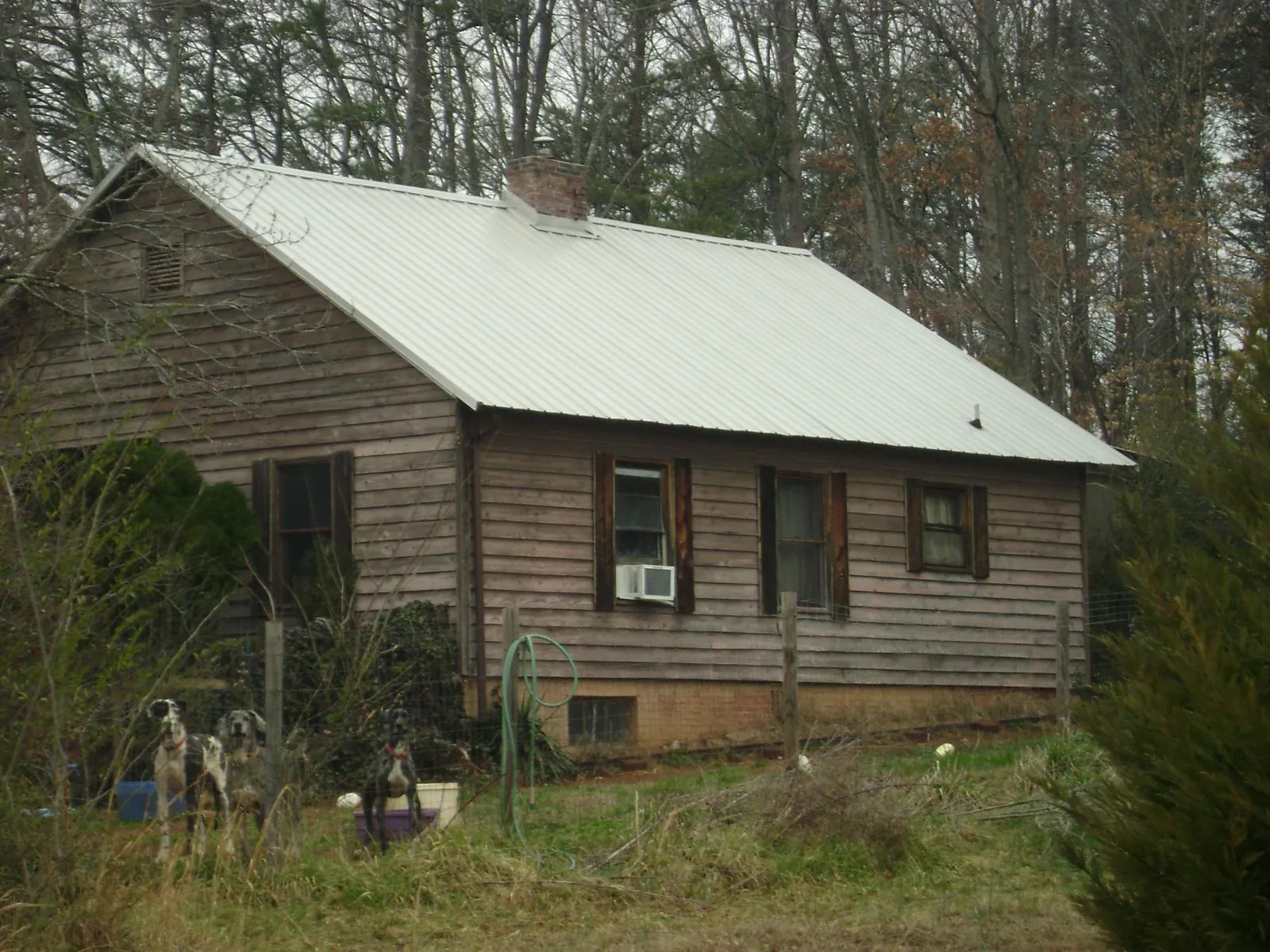 White metal roof on an old wood sided farmhouse, from a Metal Roof Installation job in Okeana